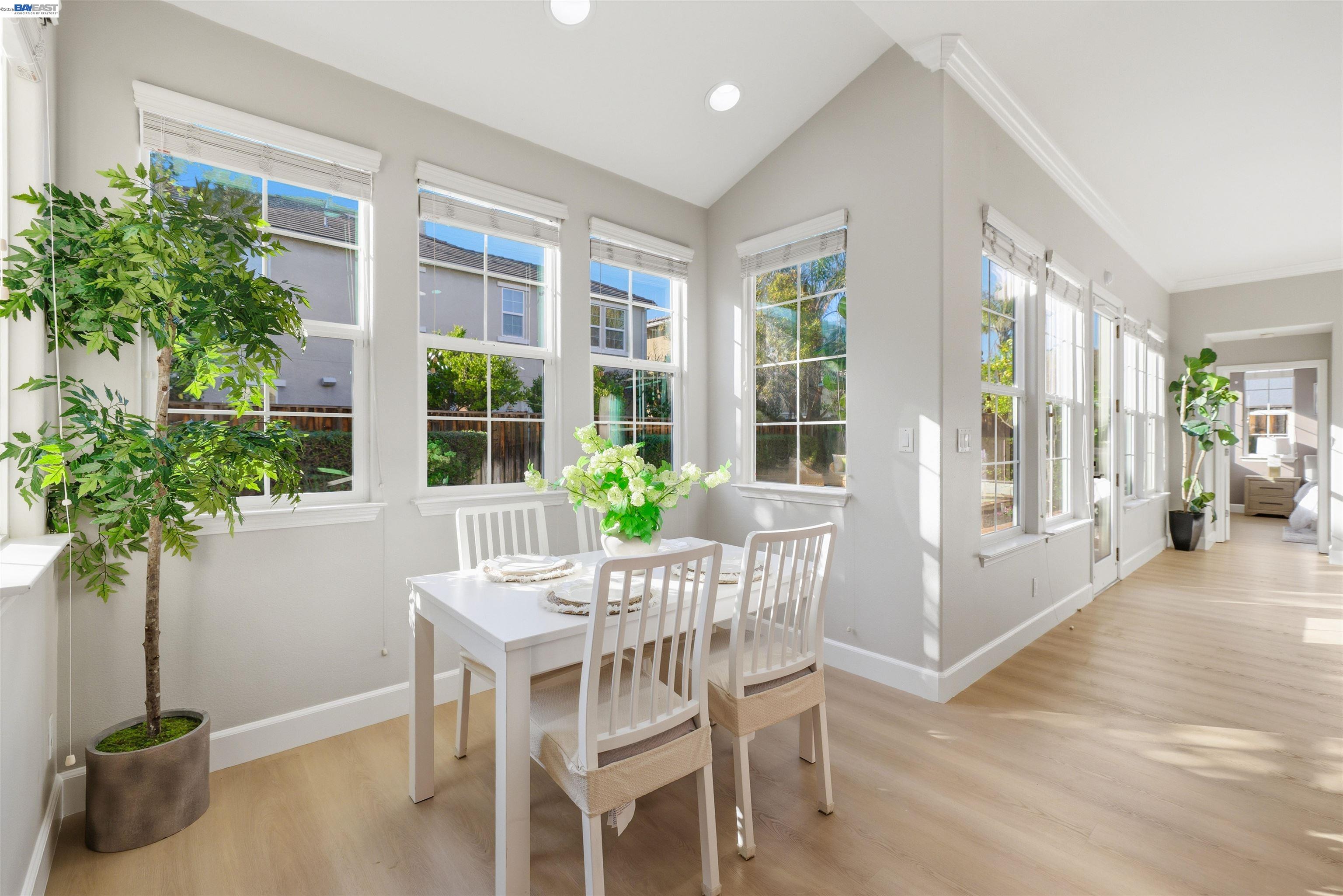 116 Macedon Court San Ramon, CA 94582 - Photo 20 of 60 a dining room with furniture potted plants and wooden floor