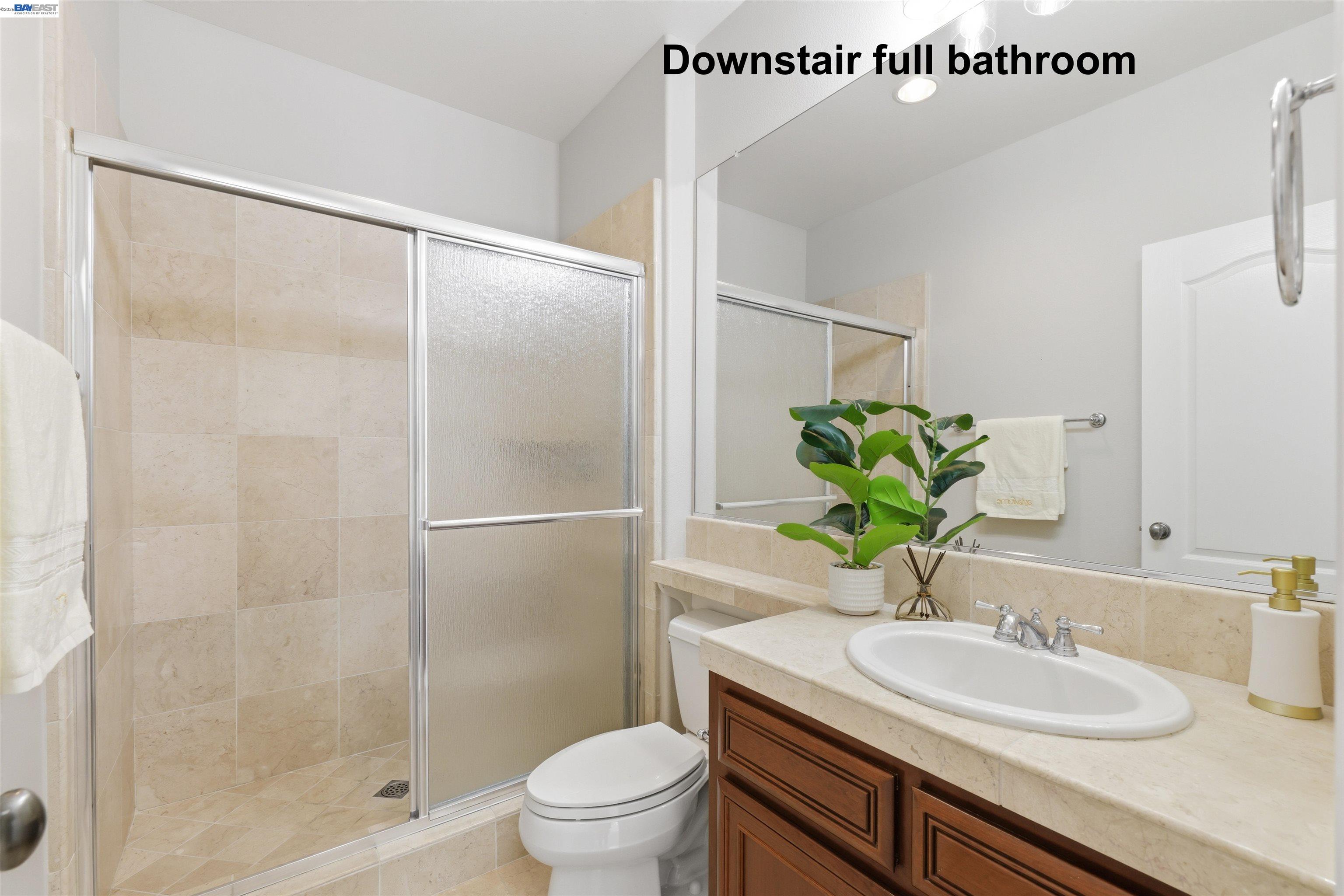 116 Macedon Court San Ramon, CA 94582 - Photo 28 of 60 a bathroom with a granite countertop sink a toilet and shower