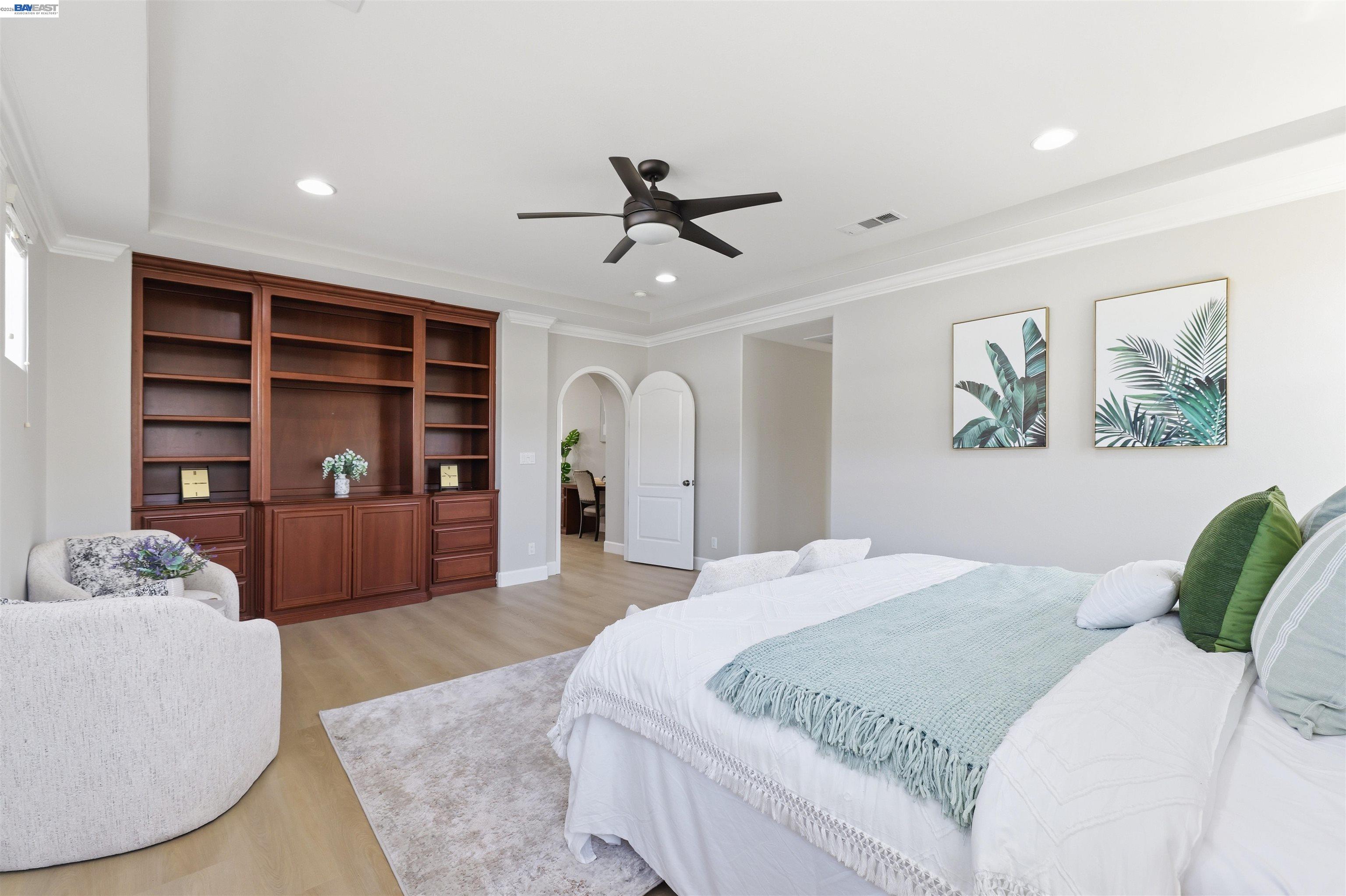 116 Macedon Court San Ramon, CA 94582 - Photo 38 of 60 a bedroom with a large bed and a chandelier