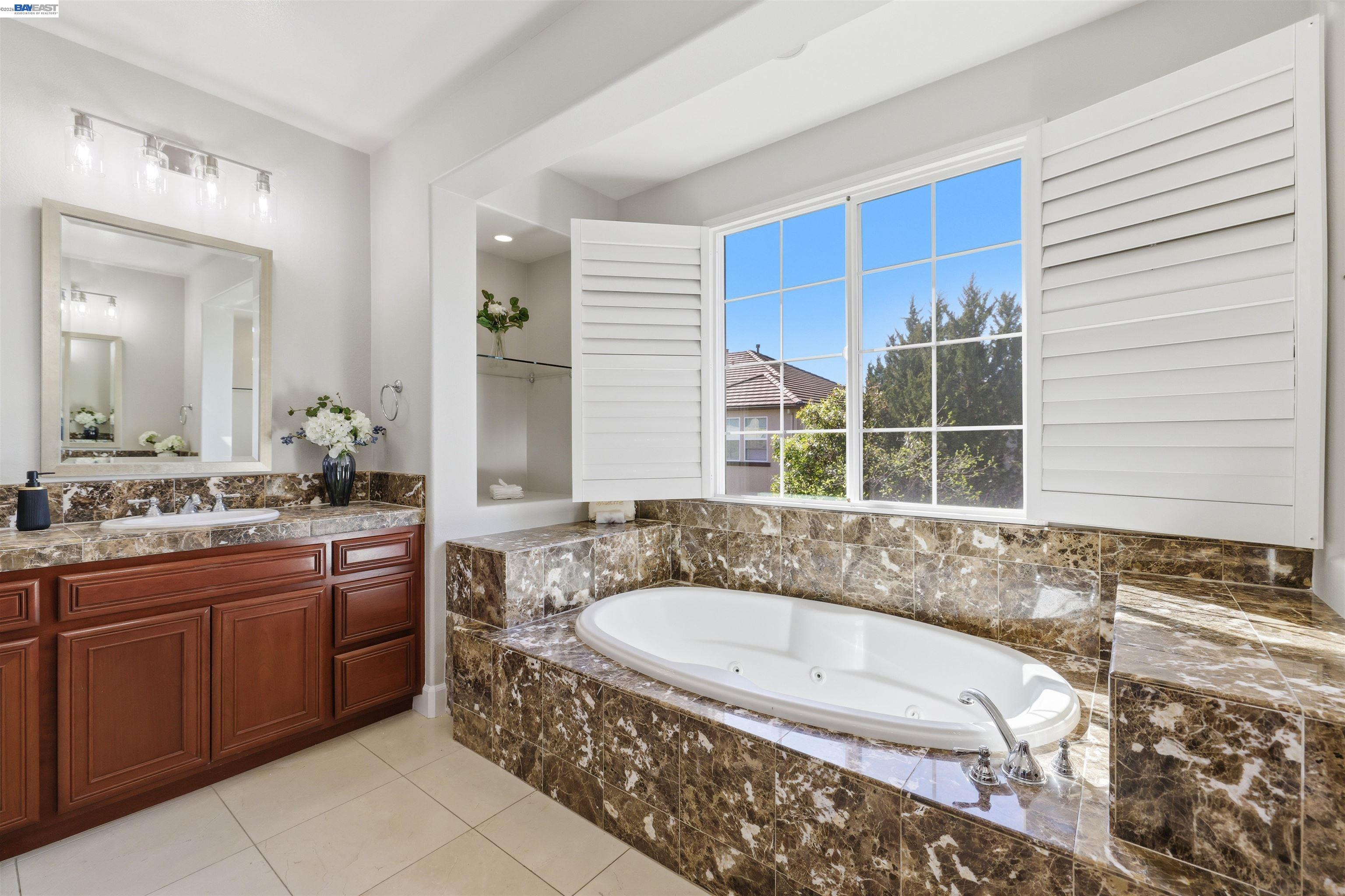 116 Macedon Court San Ramon, CA 94582 - Photo 39 of 60 a bathroom with a granite countertop tub sink and mirror
