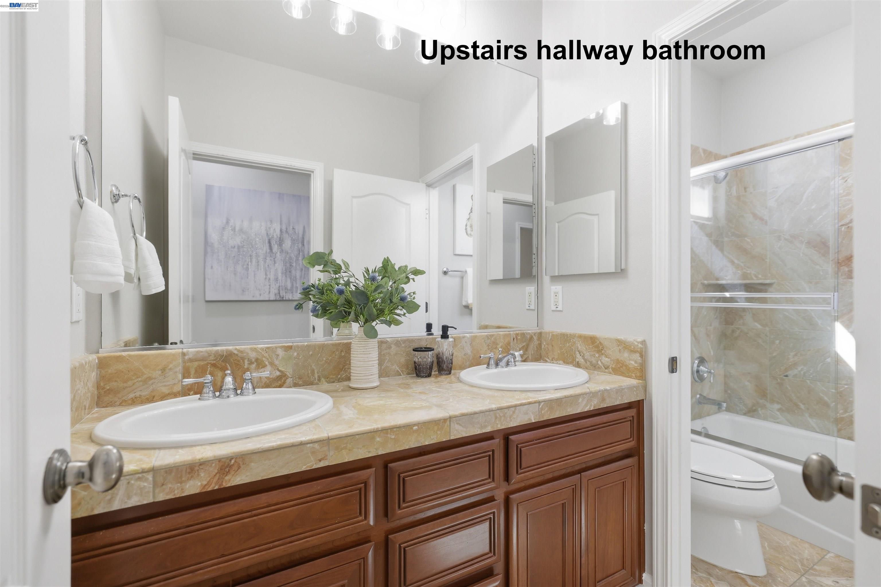 116 Macedon Court San Ramon, CA 94582 - Photo 46 of 60 a bathroom with a granite countertop sink a toilet and shower