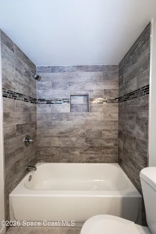 a bathroom with a shower and a bathtub