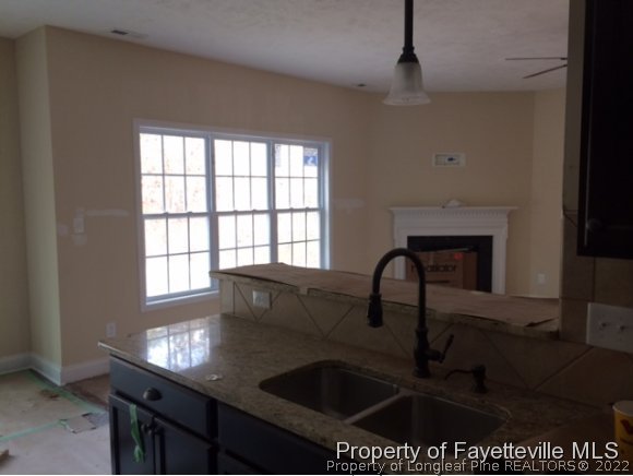 606 Longleaf Road Aberdeen, NC 28315 - Photo 4 of 13 a kitchen with a sink a counter top space and a window
