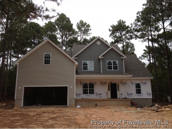 606 Longleaf Road Aberdeen, NC 28315 - Photo 9 of 13 a front view of a house with a garden