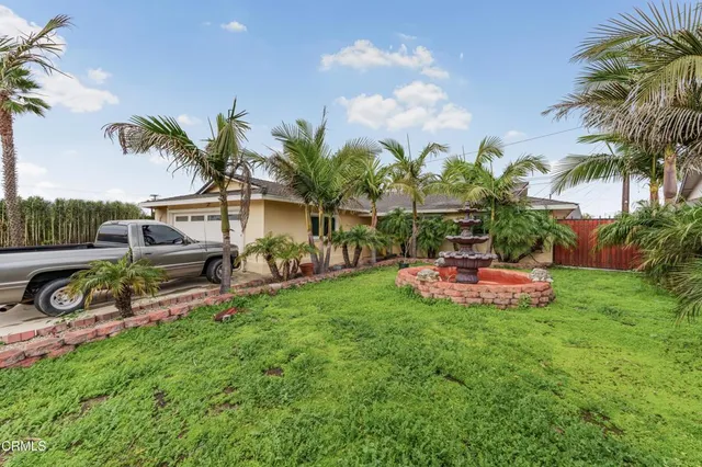 a view of a backyard with a garden and entertaining space