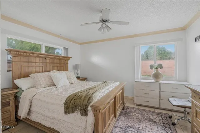 a bedroom with a bed and a ceiling fan