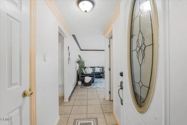 a view of a hallway with wooden floor and a bathroom