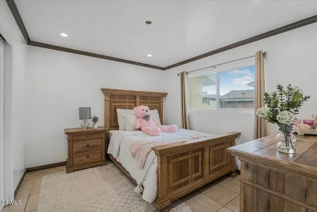 a bedroom with a bed and a large mirror