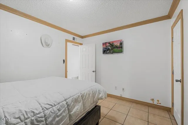 a bathroom with a granite countertop toilet sink and mirror