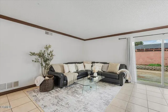 a living room with furniture a couch and a potted plant