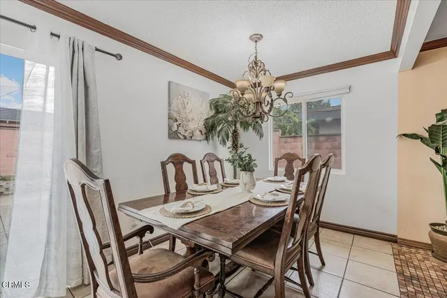 a view of a dining room with furniture and chandelier
