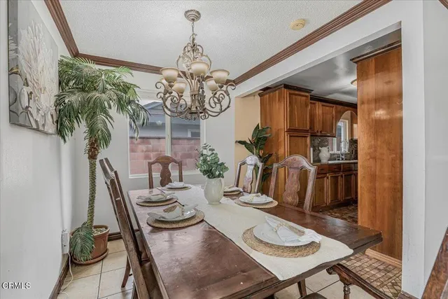a view of a dining room with furniture a chandelier and wooden floor