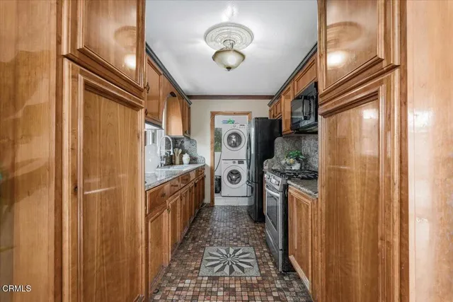 a kitchen with stainless steel appliances granite countertop a refrigerator and a stove