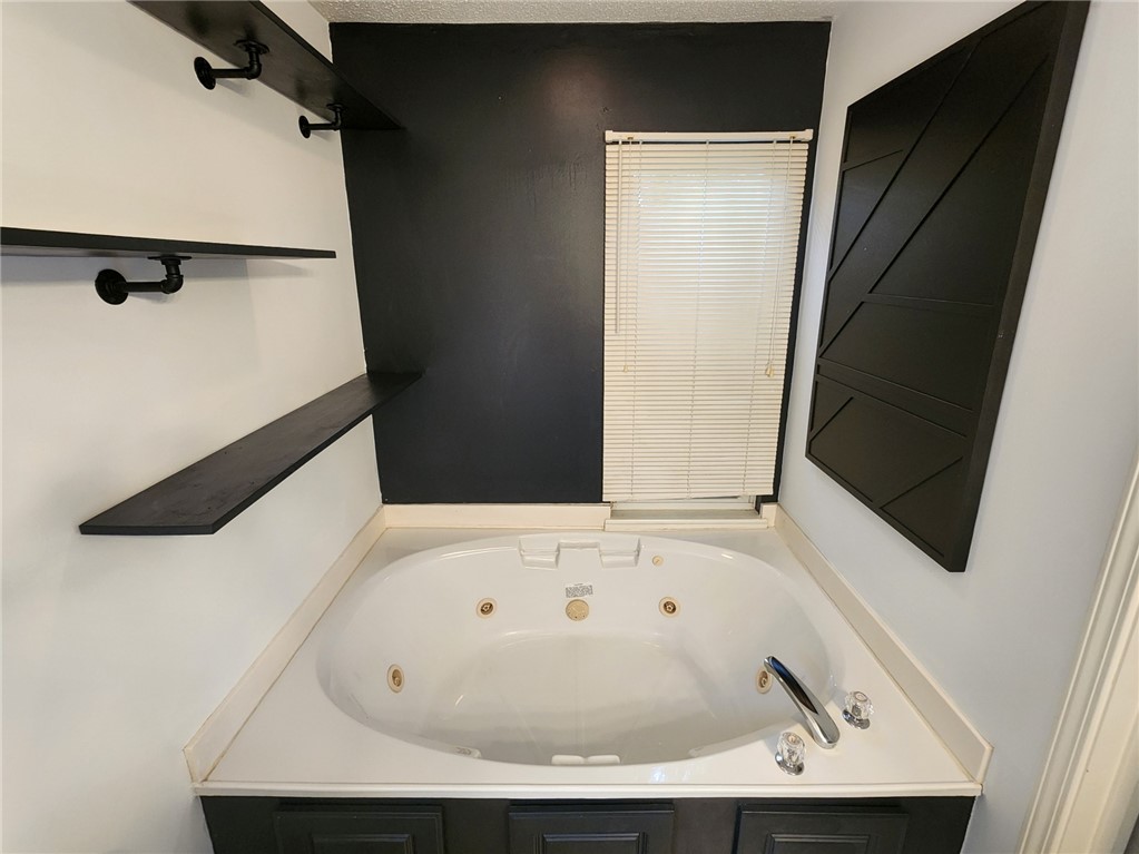 328 Springfield Circle Easley, SC 29642 - Photo 21 of 29 Indulge in relaxation within this primary bathroom featuring a corner spa tub.