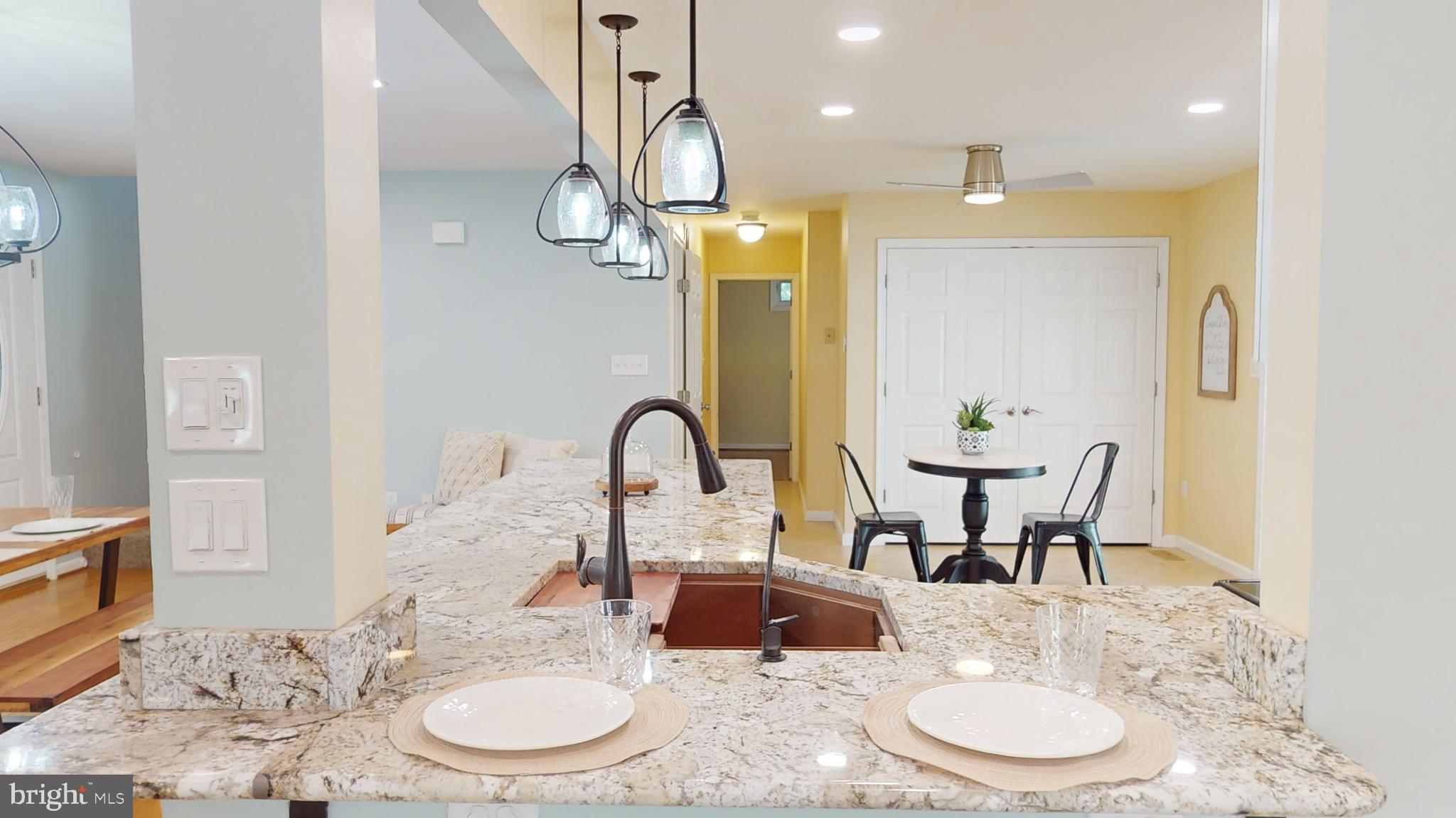 10600 Ward Road Dunkirk, MD 20754 - Photo 29 of 144 a dining room with wooden floor a chandelier a wooden table and chairs