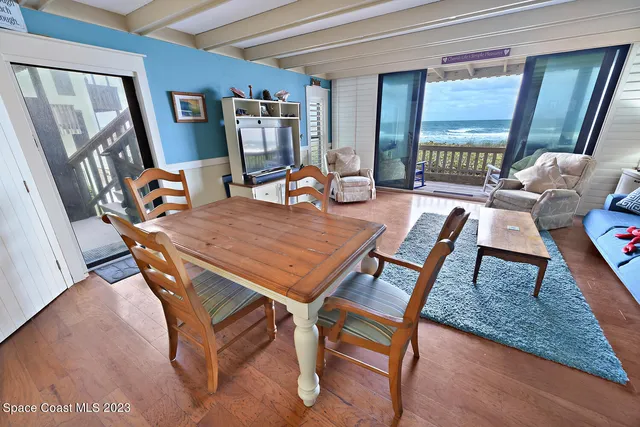 a dining room with furniture and wooden floor