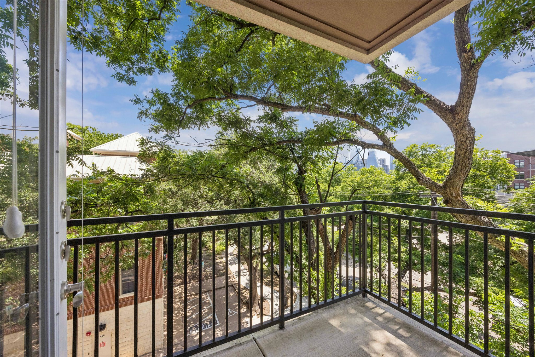 1900 Barton Springs Road, Unit 4041 Austin, TX 78704 - Photo 6 of 35 A private balcony offers verdant tree-lined views and a glimpse of the city skyline.