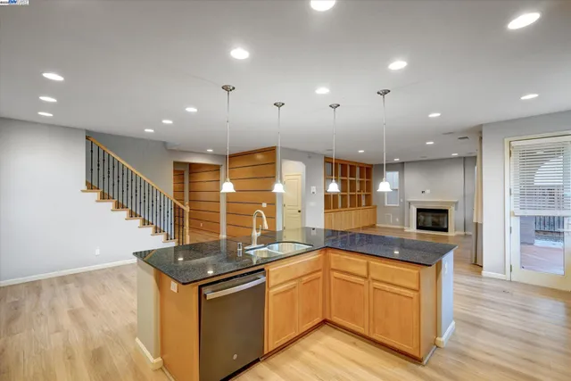 a large kitchen with stainless steel appliances granite countertop a sink and a stove