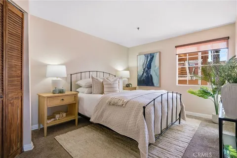 a bedroom with a large bed and a window