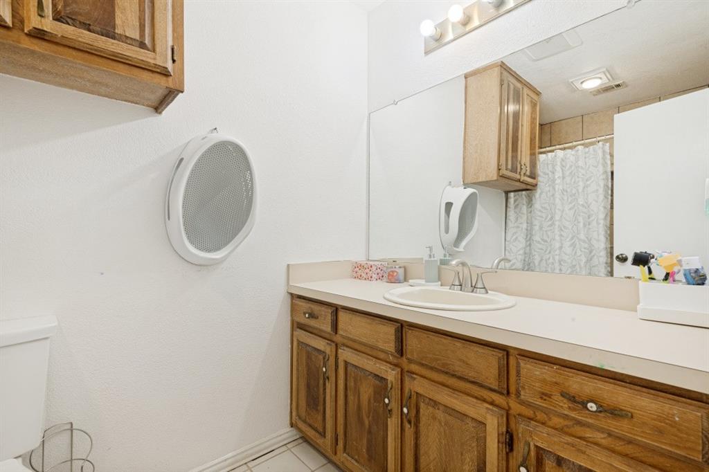 7410 Jessica Way Rowlett, TX 75088 - Photo 18 of 25 a bathroom with a sink and a mirror