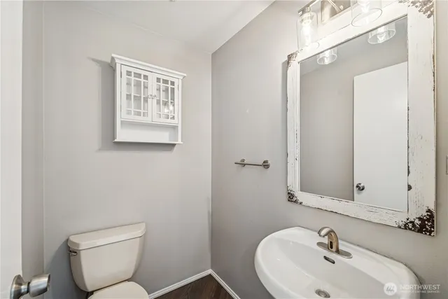 a bathroom with a toilet sink and mirror