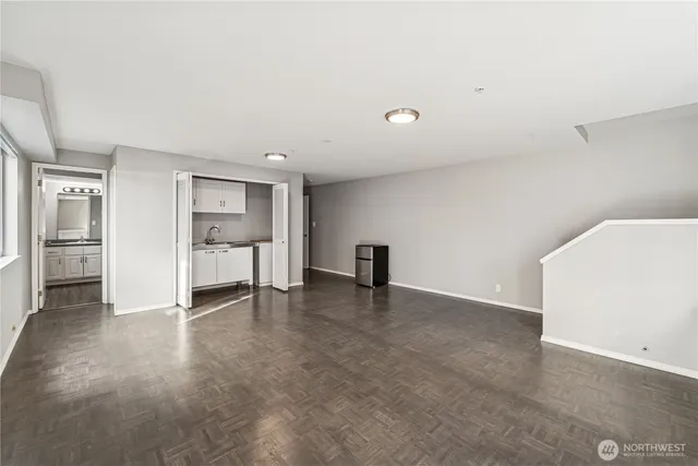 a view of an empty room with a cabinet
