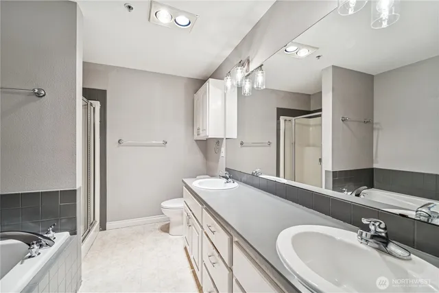 a bathroom with a sink double vanity granite and a mirror