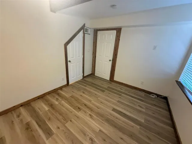 a view of a chairs and table on the wooden floor