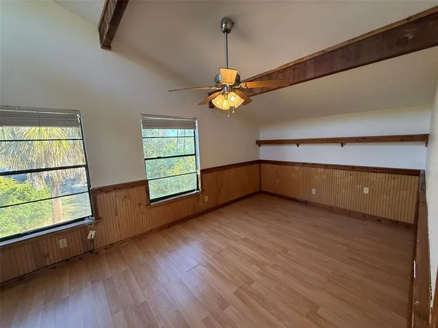 a view of a livingroom with wooden floor and a window