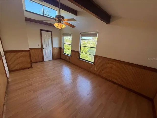 a view of room with window and ceiling fan
