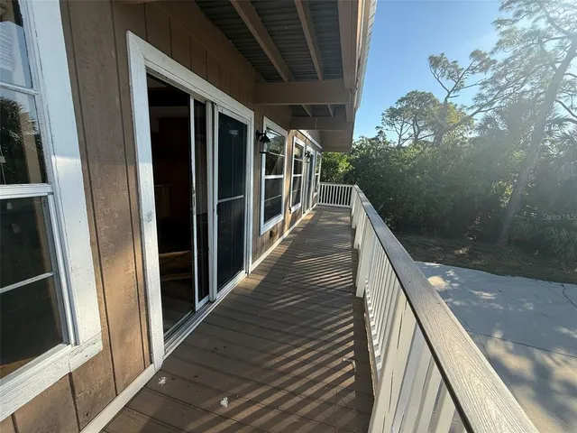a kitchen with granite countertop a refrigerator and a sink