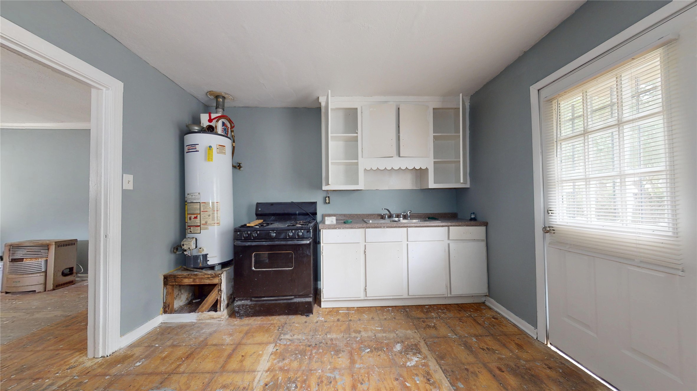 6604 Conley Street Houston, TX 77021 - Photo 10 of 28 a kitchen with a refrigerator and a stove top oven