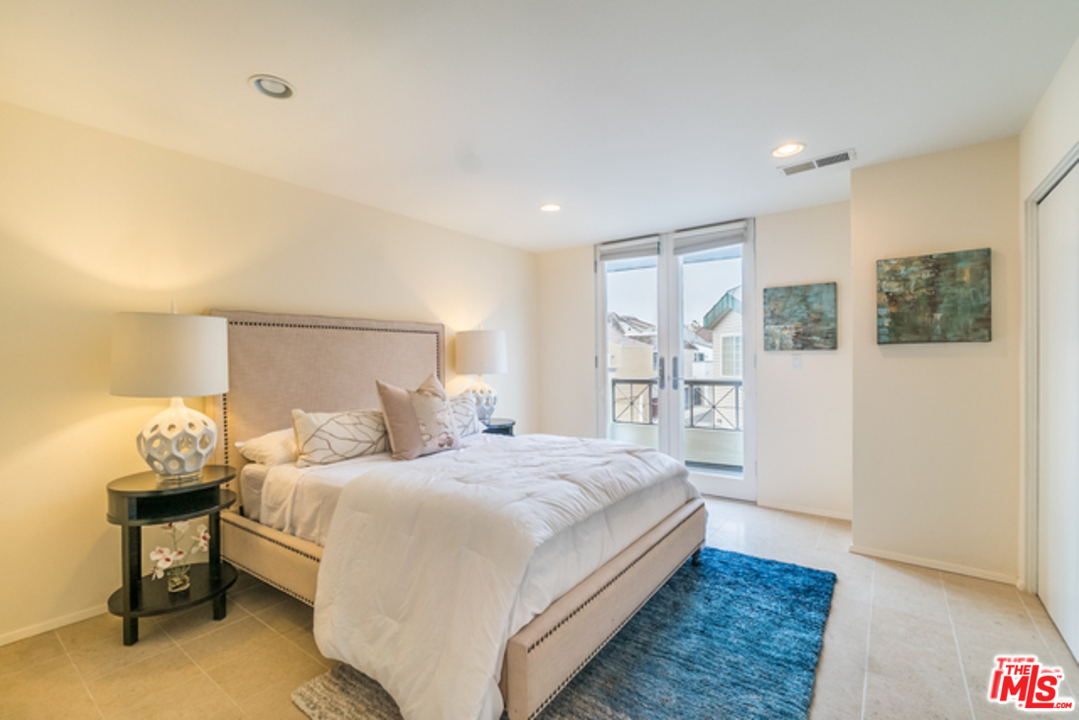 4515 Roma Court Marina del Rey, CA 90292 - Photo 12 of 31 a bedroom with a bed and a table in it
