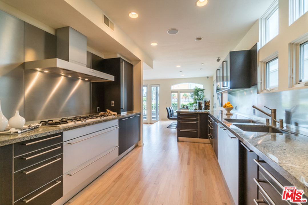4515 Roma Court Marina del Rey, CA 90292 - Photo 10 of 31 a kitchen with stainless steel appliances kitchen island granite countertop a stove and a sink