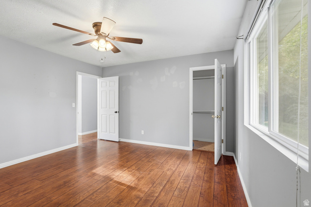 338 South 370 West Logan, UT 84321 - Photo 14 of 33 Spacious room featuring rich wood-finish flooring, light gray walls, and white trim