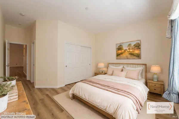 a bedroom with a bed and a painting on the wall