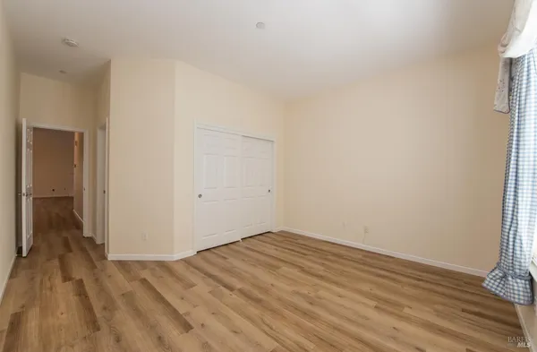 a view of a room with wooden floor