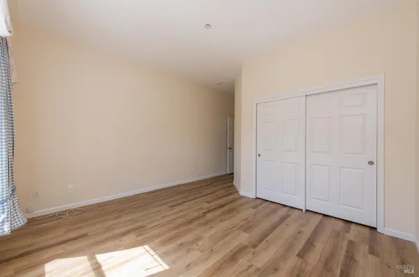 a view of an empty room and wooden floor