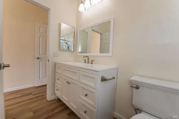 a bathroom with a sink a toilet and a mirror