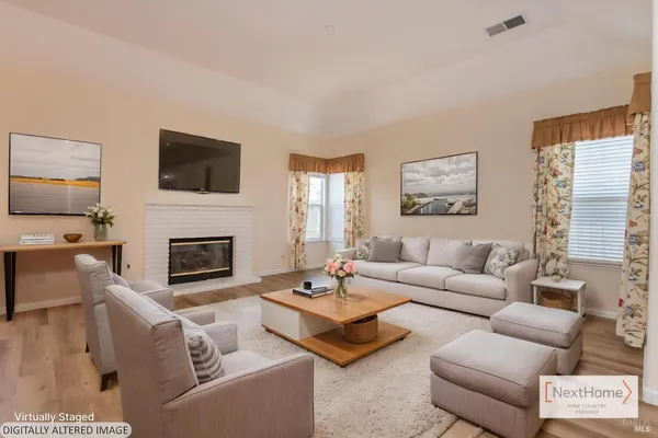 a living room with furniture a fireplace and a flat screen tv