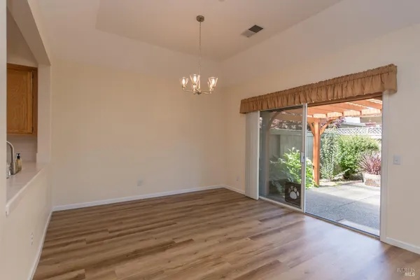 a view of a room with wooden floor and outdoor space