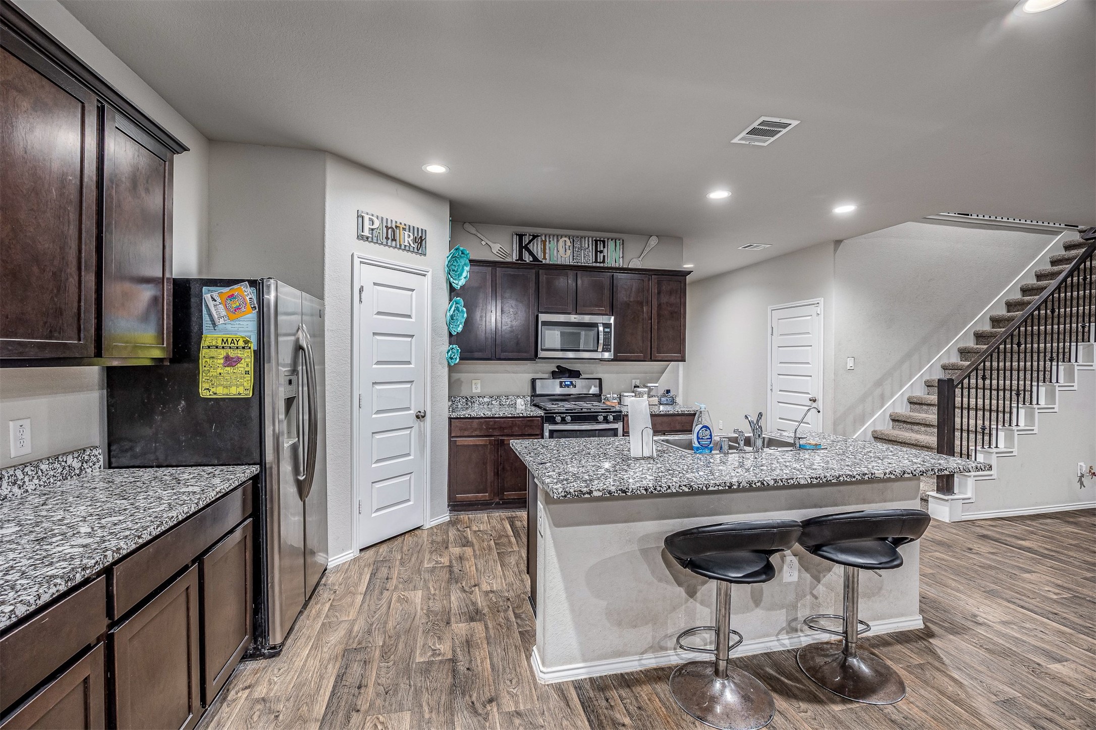 3907 Hawaiian Court Baytown, TX 77521 - Photo 21 of 40 a kitchen with stainless steel appliances granite countertop a stove refrigerator and cabinets