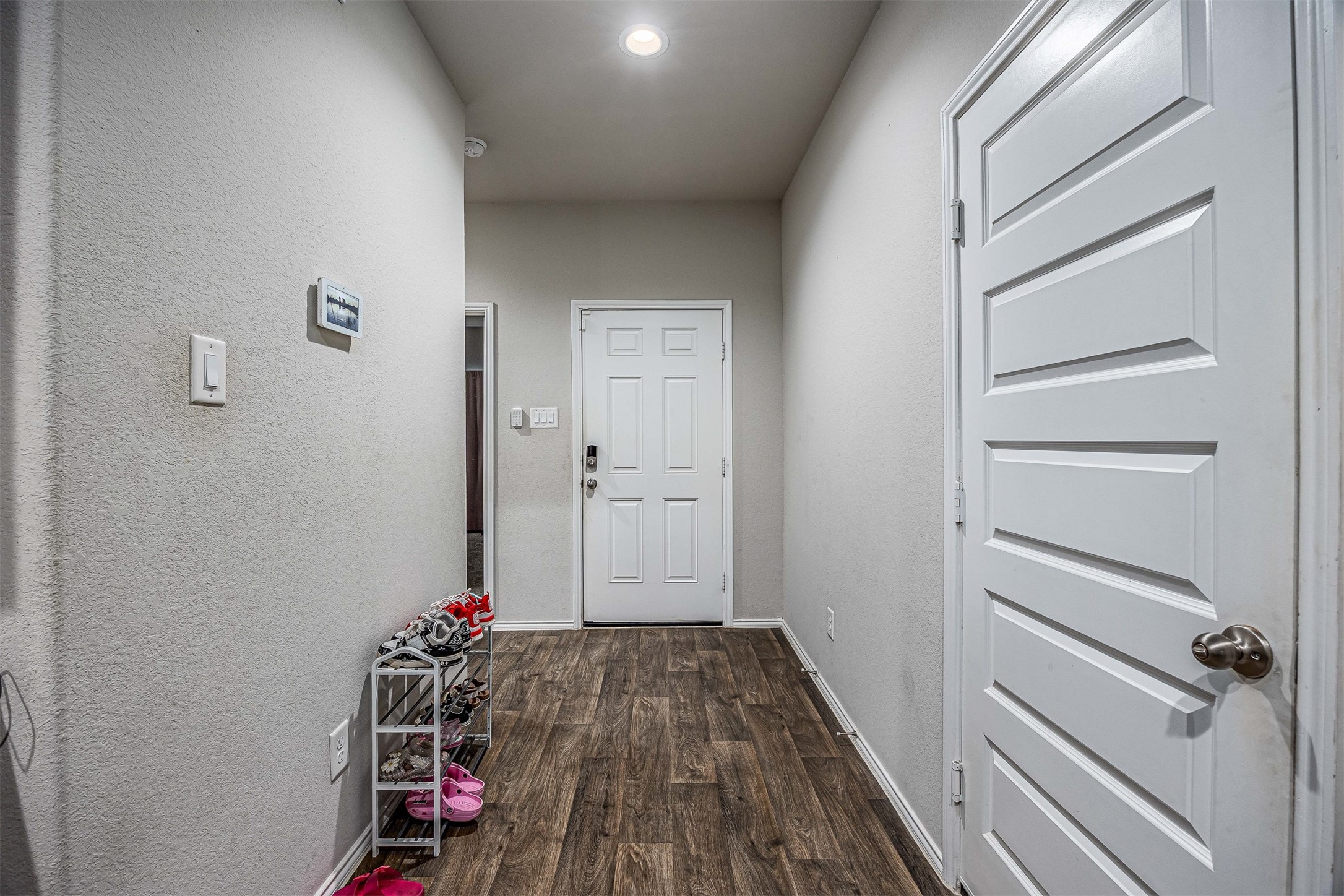 3907 Hawaiian Court Baytown, TX 77521 - Photo 39 of 40 a view of a hallway with wooden floor and closet