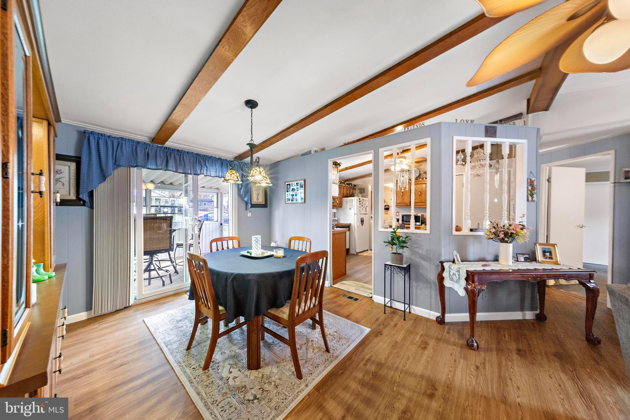 154 Brighton Road Barnegat, NJ 08005 - Photo 13 of 44 a dining room with furniture a rug a potted plant and a chandelier