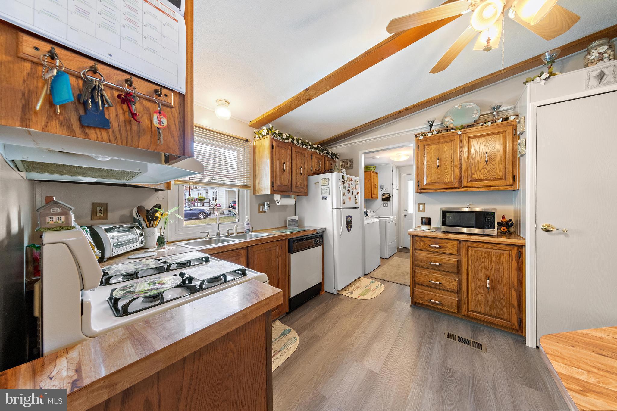 154 Brighton Road Barnegat, NJ 08005 - Photo 19 of 44 a kitchen with stainless steel appliances granite countertop a stove a sink dishwasher and a refrigerator with wooden floor