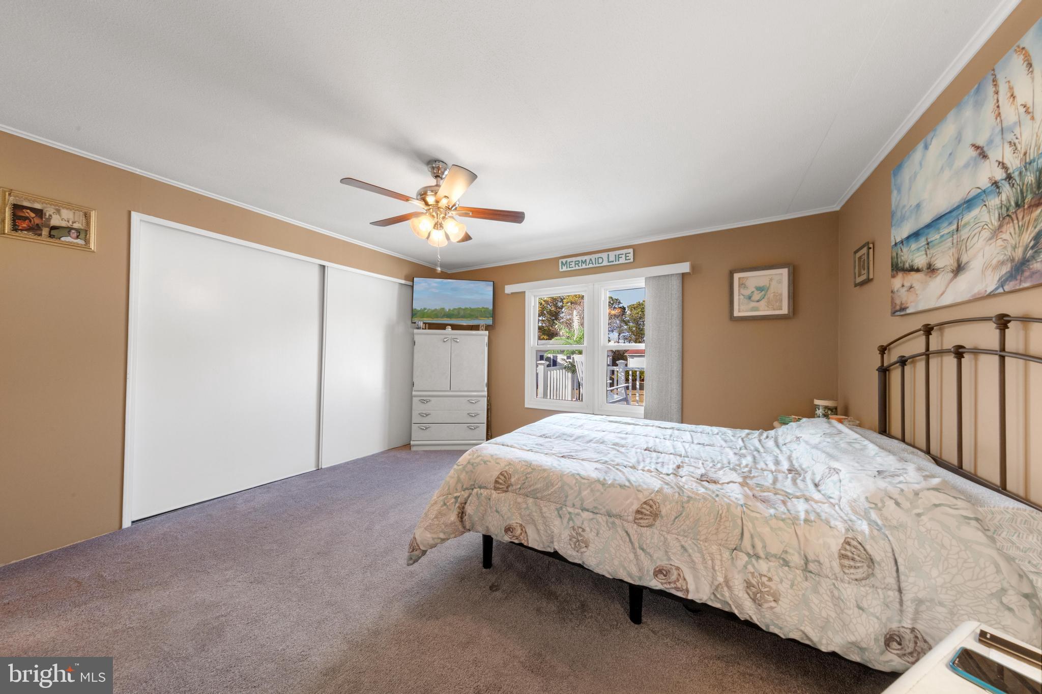 154 Brighton Road Barnegat, NJ 08005 - Photo 25 of 44 a bedroom with a large bed chandelier and a window