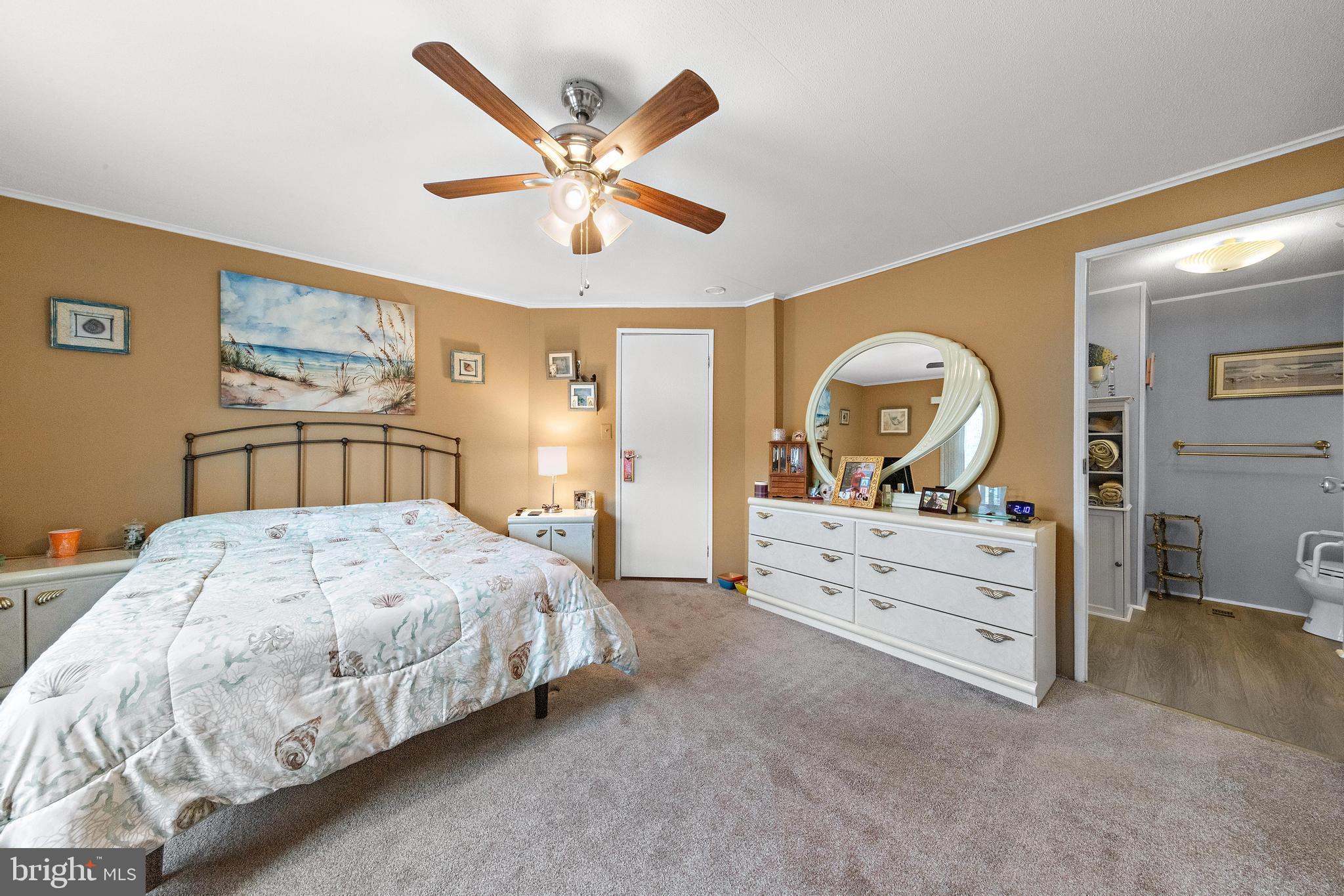 154 Brighton Road Barnegat, NJ 08005 - Photo 27 of 44 a bedroom with a large bed and a chandelier