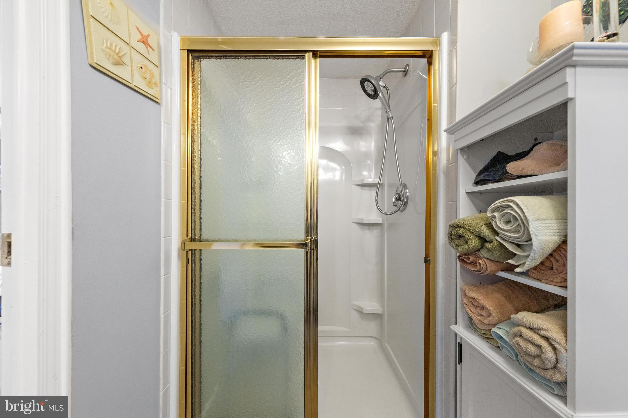 154 Brighton Road Barnegat, NJ 08005 - Photo 29 of 44 a bathroom with a glass shower door and a sink