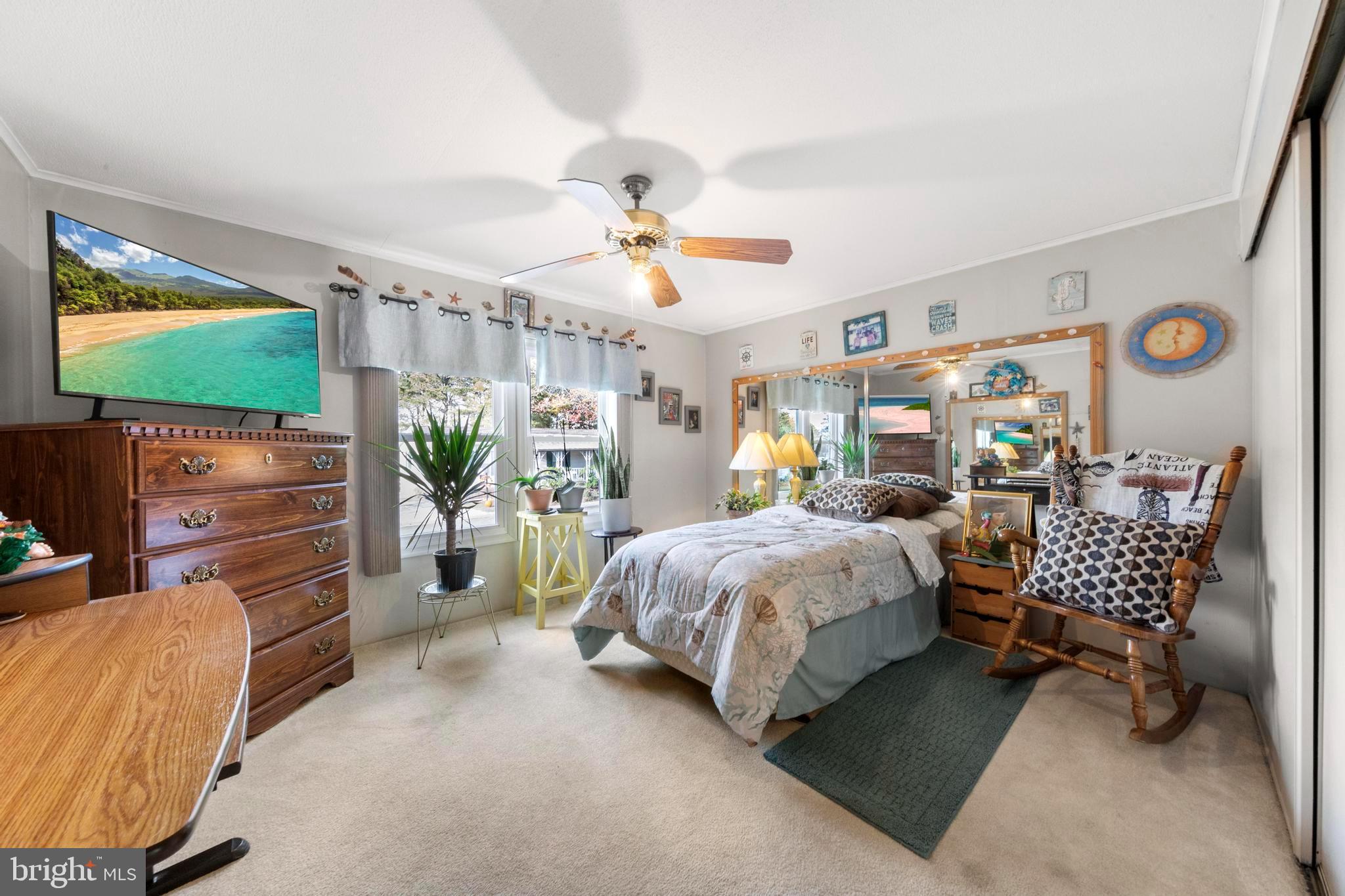 154 Brighton Road Barnegat, NJ 08005 - Photo 30 of 44 a bedroom with bed and a flat tv screen on dresser