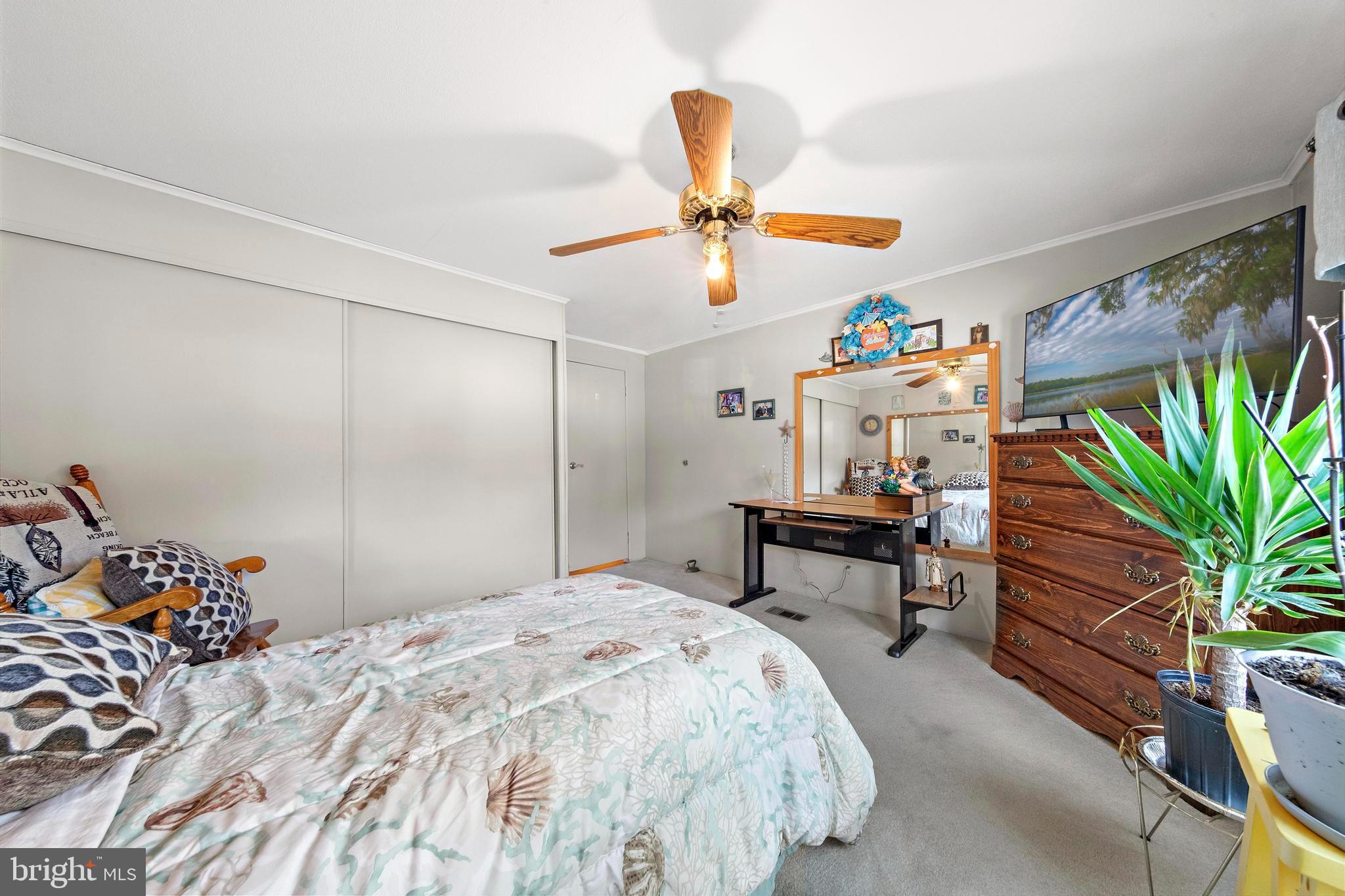 154 Brighton Road Barnegat, NJ 08005 - Photo 31 of 44 a bedroom with furniture and a chandelier